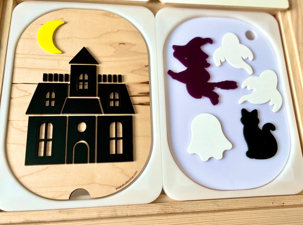 Wooden shapes puzzle featuring a black haunted house with a yellow crescent moon and separate ghosts, witch, and cat pieces