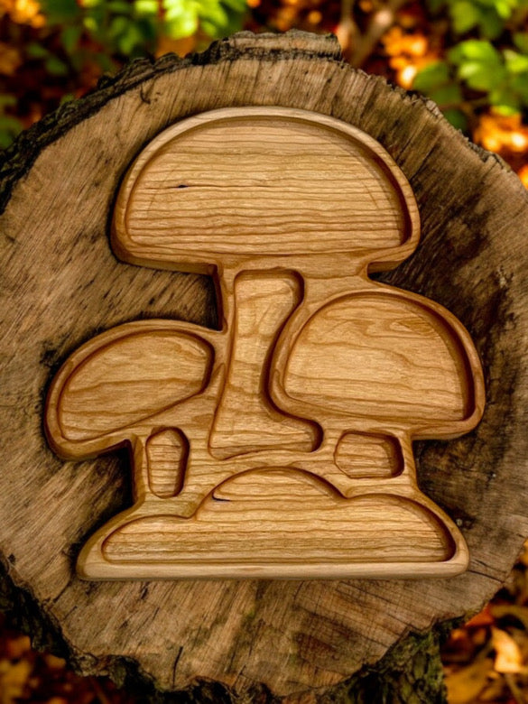 Wooden puzzle shaped like three stylized mushrooms on a tree stump with autumn leaves in the background