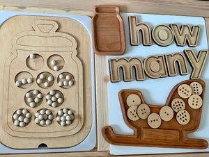 Wooden cookie jar insert with 10 numbered cookies featuring chocolate chip holes and wooden “how many” letters on table
