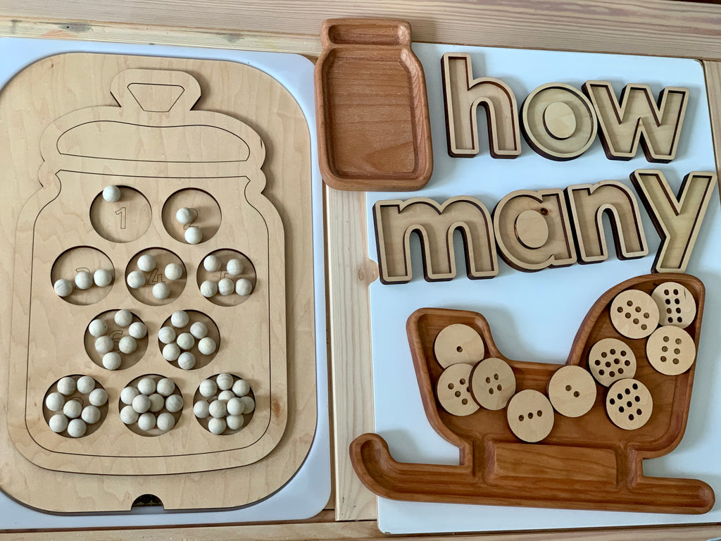 Wooden cookie jar insert with 10 numbered cookies featuring chocolate chip holes and wooden “how many” letters on table