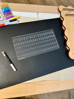 Clear acrylic number line board featuring increments from 0 to 40, displayed on black mat with dry erase marker nearby