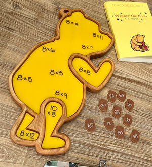 Little Dry Erasables - Set of 10 Honey Pots featuring a handcrafted wooden bear-shaped tray with yellow dry erase surface and multiplication equations, scattered wooden acorn pieces with answers, designed as homeschool educational resources.
