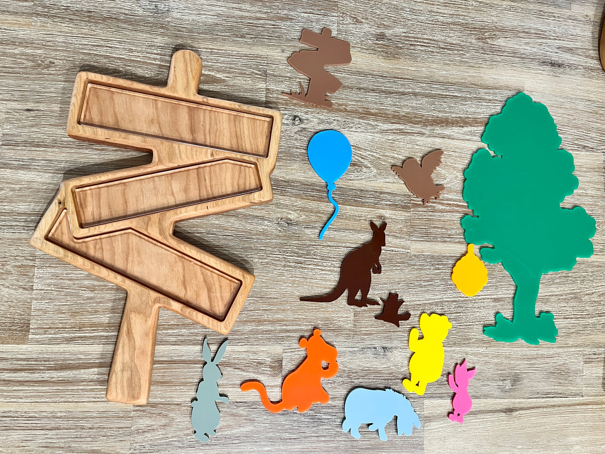 Large Woodland Forest Sign Plate / Sensory Tray with handcrafted wooden pieces shaped like animals, trees, and balloons arranged on a natural wood surface, homeschool education resources.