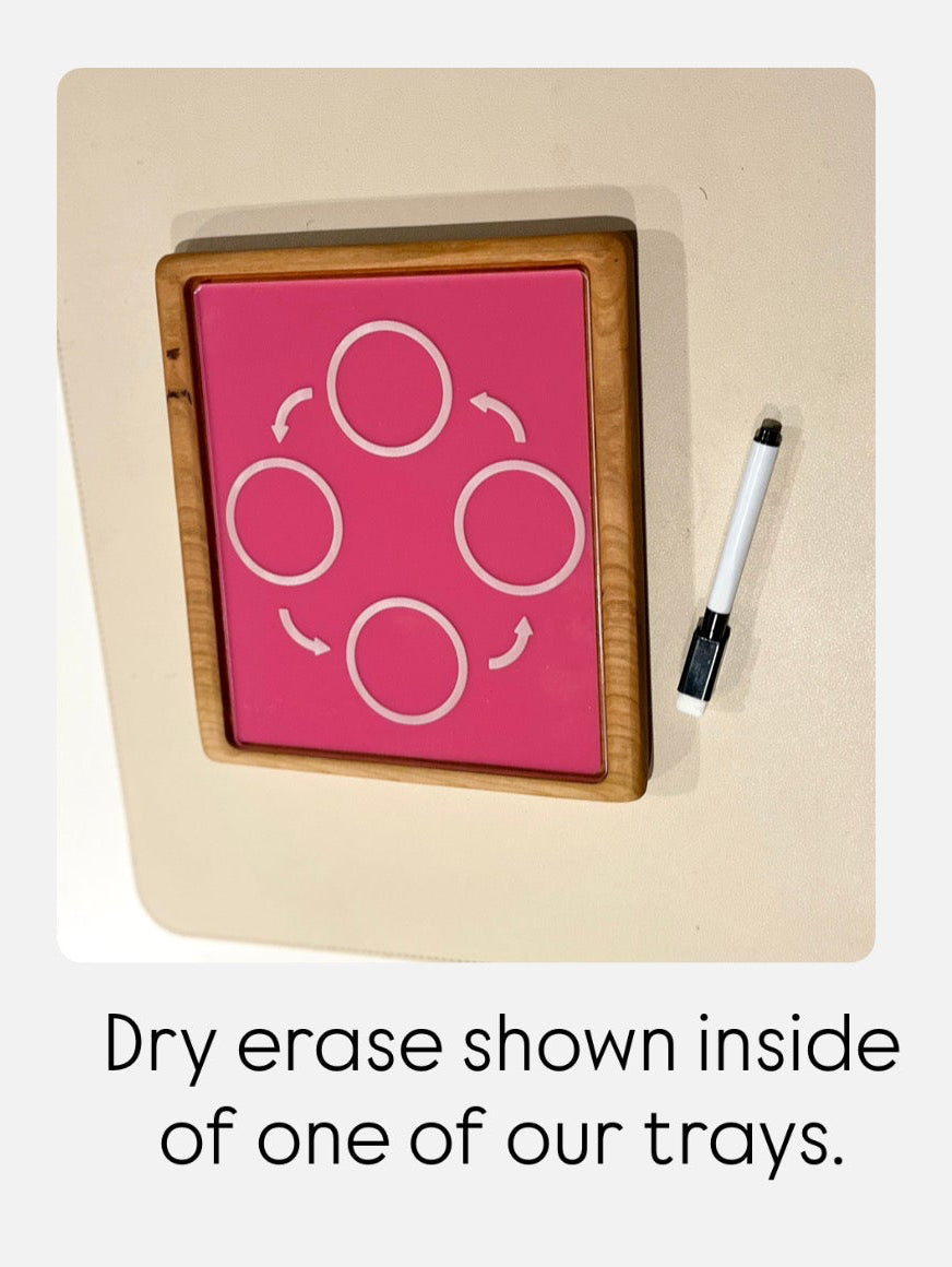 Rectangular wooden-framed dry erase board with four connected white circles and a black dry erase marker on beige surface