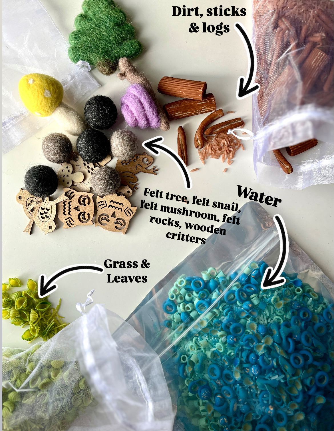 Assorted natural play materials including felt trees, wooden animals, felt balls, plastic sticks, green leaves, and blue ring beads in bags