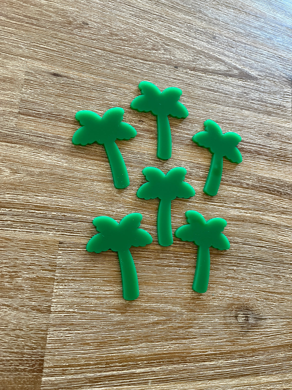 Six small green palm tree shapes made of durable material arranged on a wooden surface, Little Dry Erasables - Palm Trees, handcrafted, homeschool, education resources.