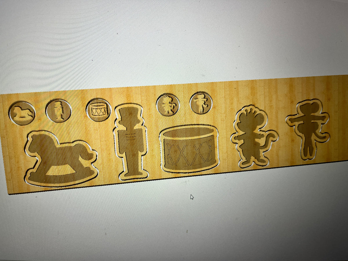Wooden puzzle board with cutouts of a rocking horse, nutcracker, drum, clown, and gingerbread man on a light background