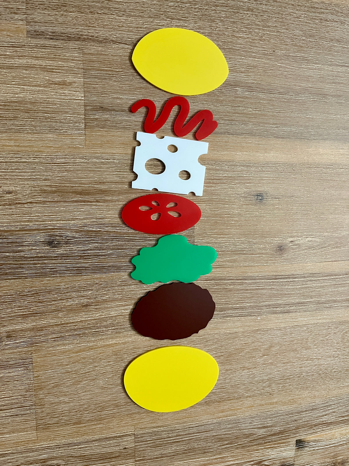 Little Dry Erasables - Burger 7 Piece Set displaying handcrafted wooden play pieces of bun halves, ketchup, cheese slice, tomato, lettuce, and burger patty for homeschool educational resources.