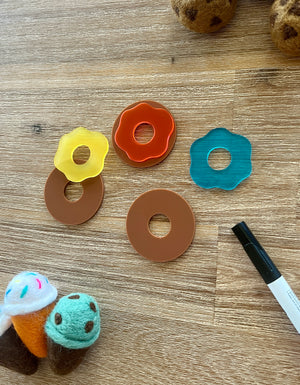 Little Dry Erasables - Donuts with Icing featuring handcrafted wooden donut bases paired with colorful translucent icing pieces, accompanied by felt ice cream cones and a black marker, handcrafted homeschool education resources.