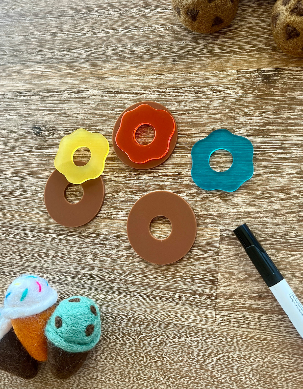 Little Dry Erasables - Donuts with Icing featuring handcrafted wooden donut bases paired with colorful translucent icing pieces, accompanied by felt ice cream cones and a black marker, handcrafted homeschool education resources.