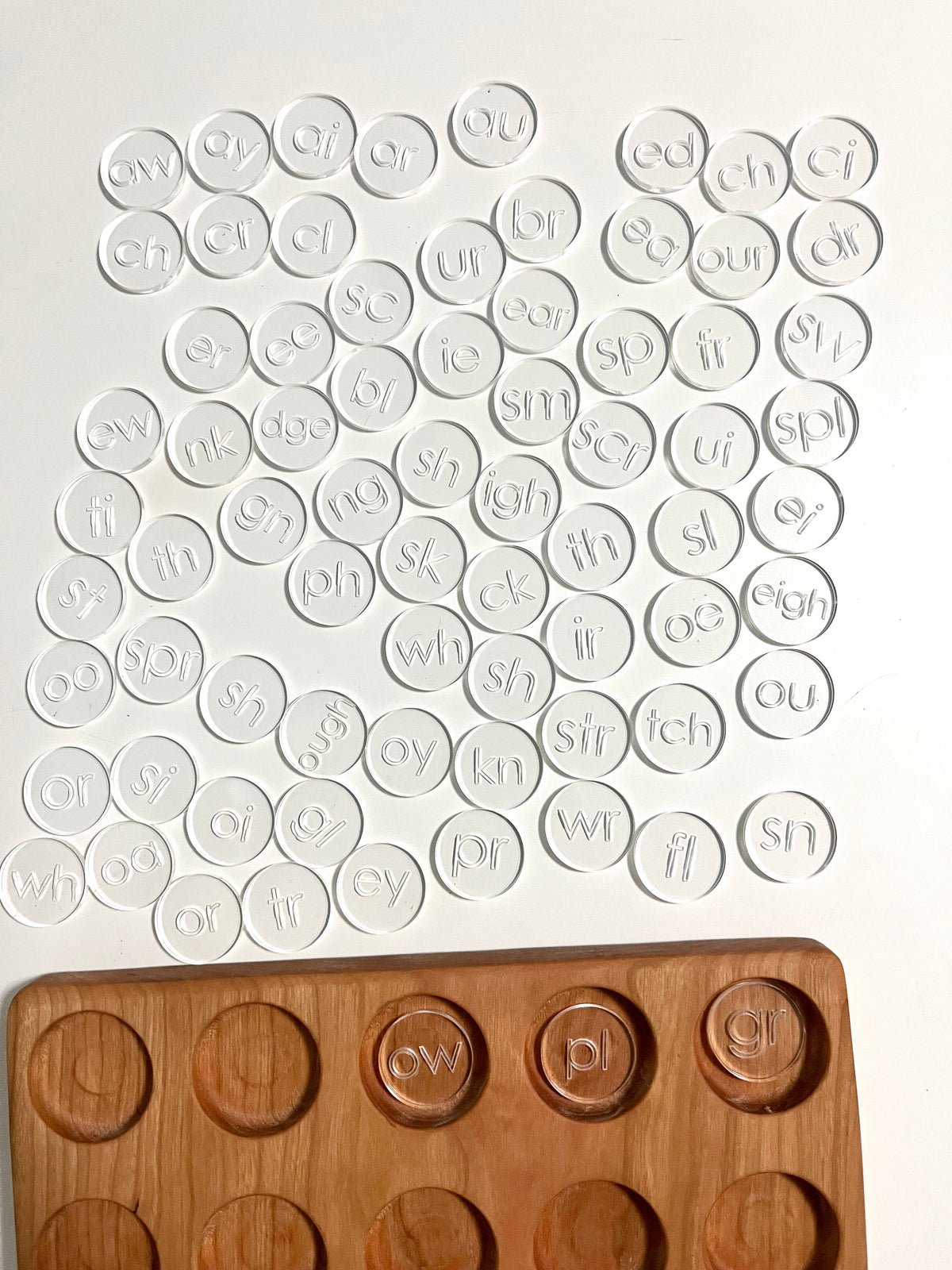 Mini Wood or Clear Acrylic Discs | Set of 75 Blends and Digraphs featuring clear engraved discs with phonics blends arranged near a handcrafted wood tray, unique homeschool education resources.