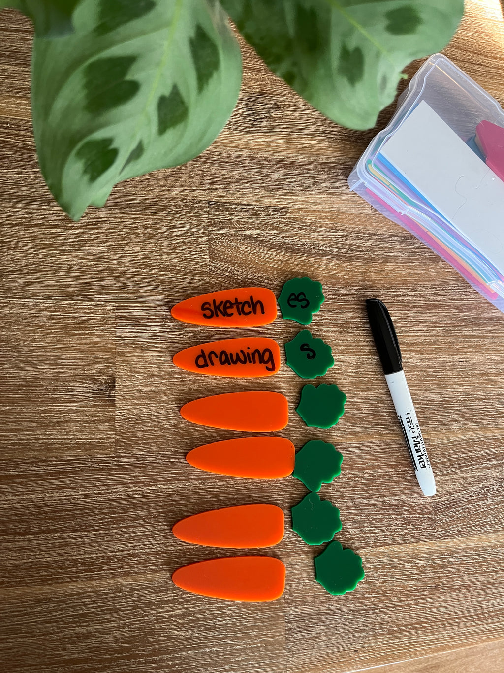 Little Dry Erasables - Small Carrots & Tops - Set of 6 / 12 Pcs Total featuring bright orange carrot pieces paired with green leafy tops, a black dry erase marker on a wood surface, handcrafted homeschool education resources.