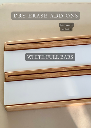 Two wooden dry erase add-on trays with white full bar inserts on beige surface, no boards included