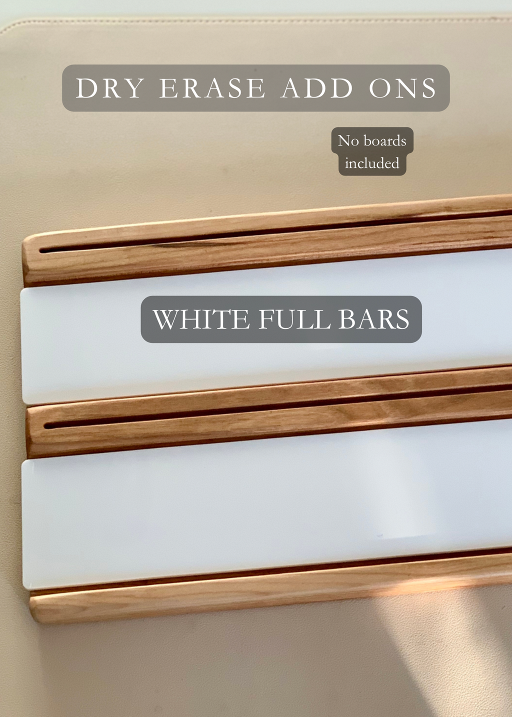 Two wooden dry erase add-on trays with white full bar inserts on beige surface, no boards included