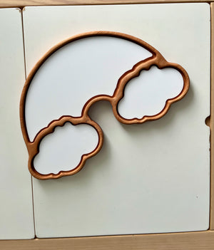 Wooden rainbow frame with two large cloud-shaped compartments on a white surface background