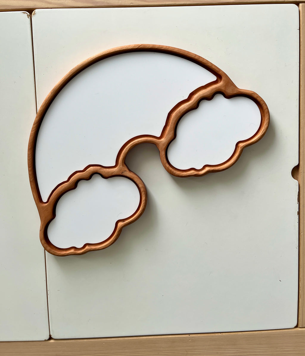 Wooden rainbow frame with two large cloud-shaped compartments on a white surface background