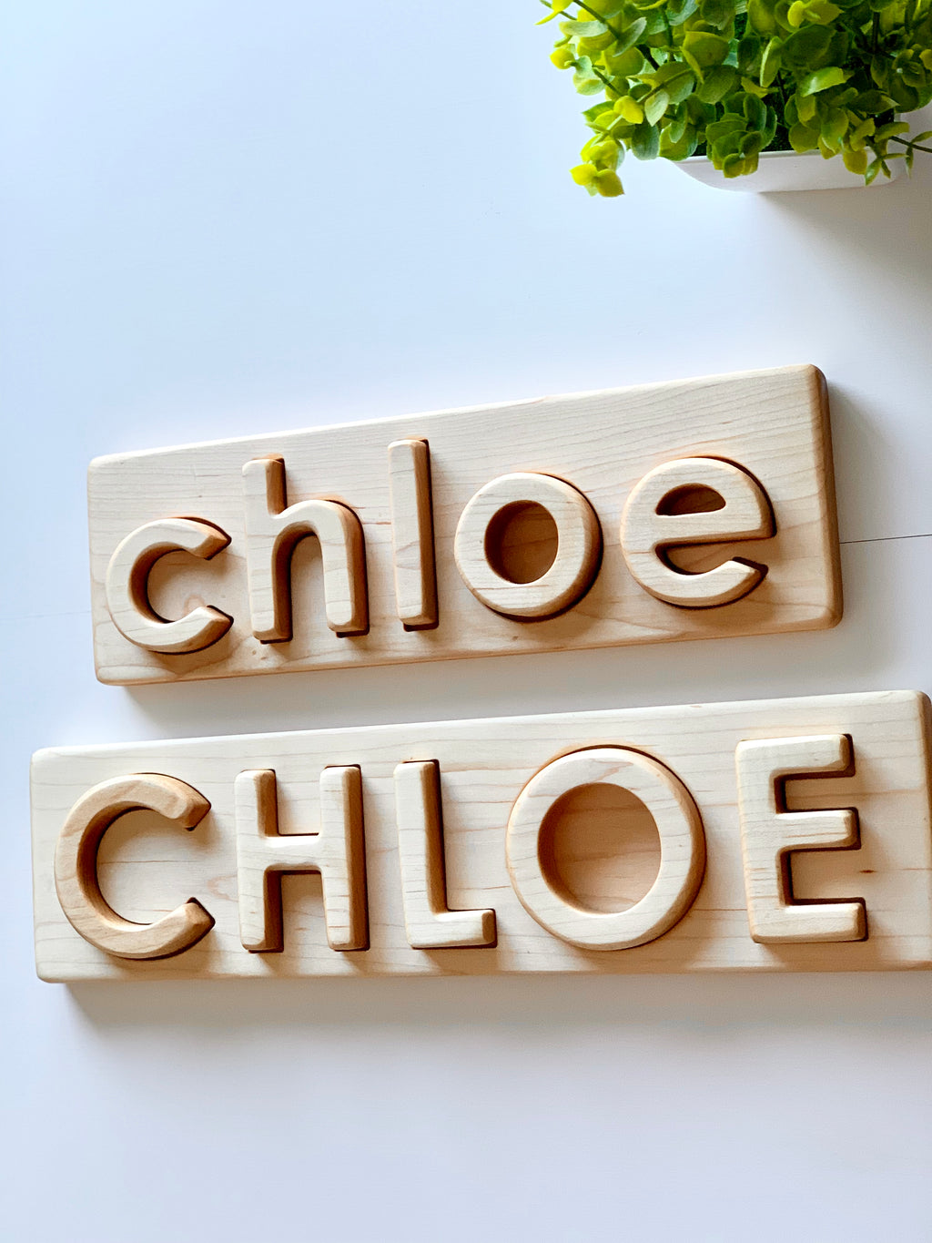 Personalized hardwood name puzzles with uppercase and lowercase letters spelling CHLOE on natural wood backgrounds