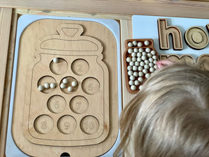Wooden Flisat table top insert shaped like a cookie jar with ten numbered cookie slots and small wooden peg cookies