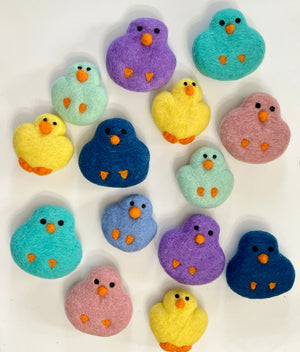 Assorted colorful felt bird shapes in blue, purple, yellow, teal, pink, and mint green on white background