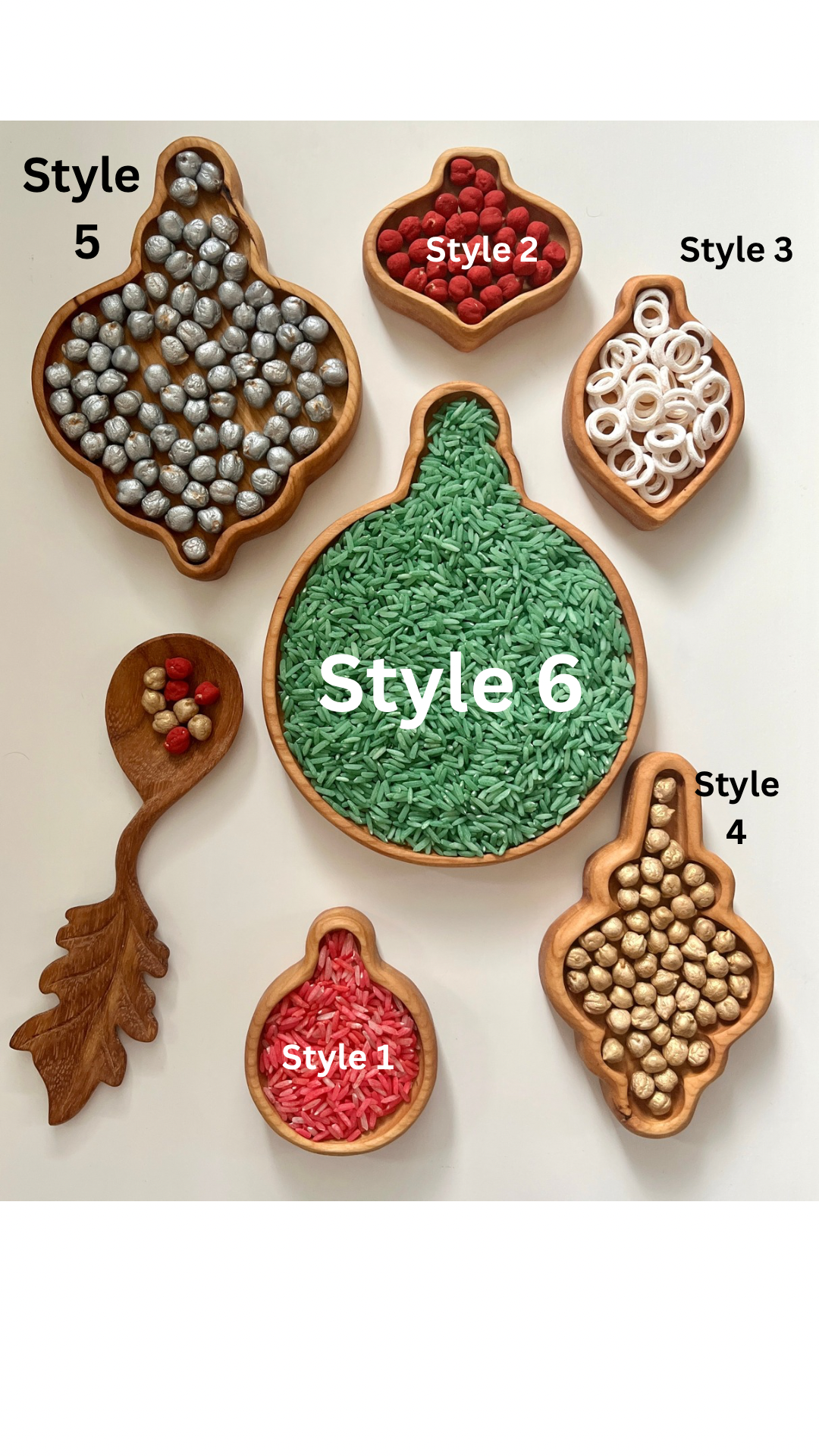 Set of six wooden trays in various ornament shapes filled with colorful rice, beads, and wooden balls on white background