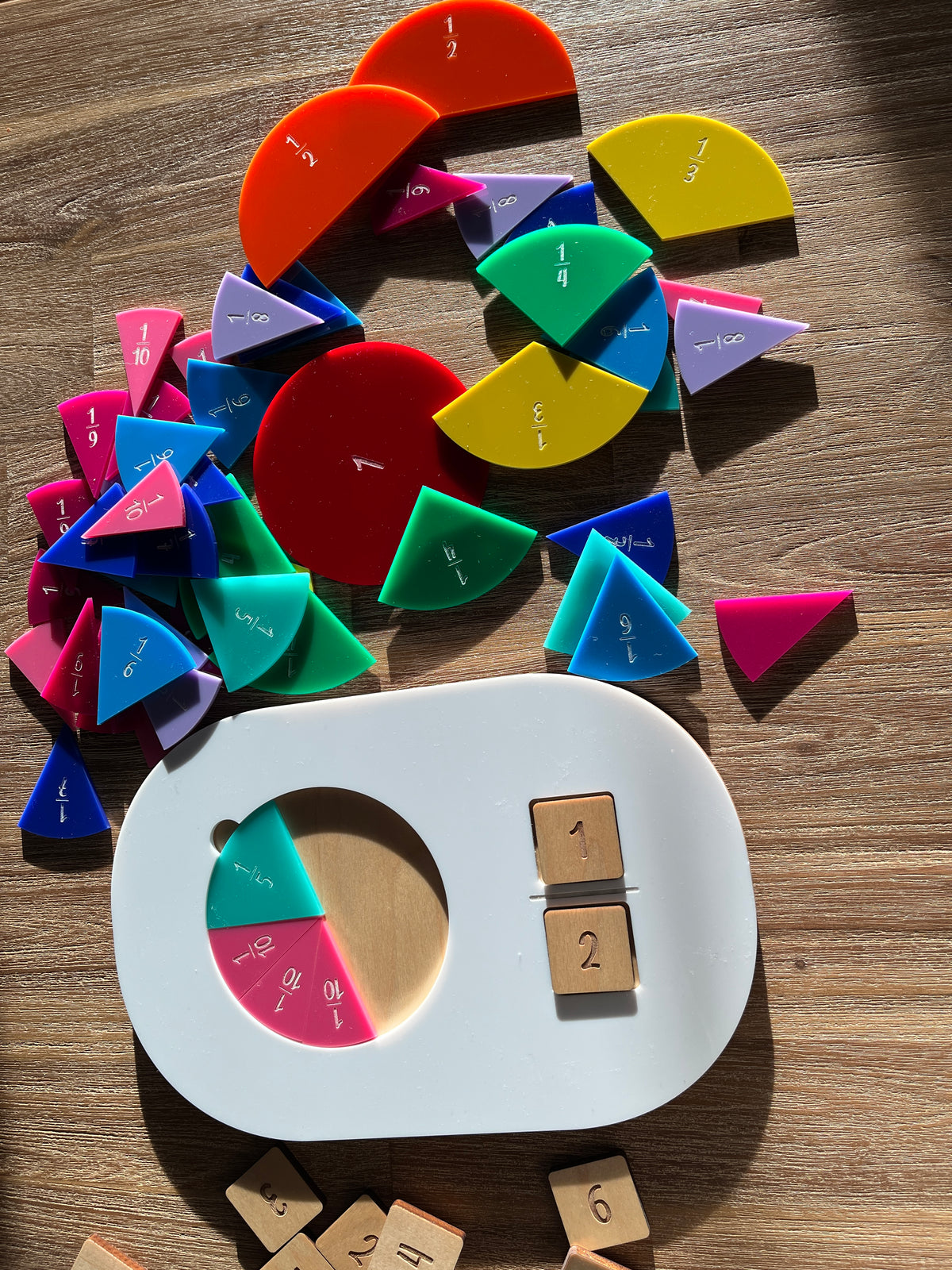 Dry Erasable Fraction Circle Tray, Fits Small Flisat Insert featuring handcrafted colorful fraction pieces and wooden number tiles arranged on a wood surface, homeschool education resources.