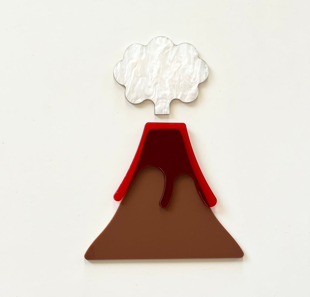 Layered acrylic volcano shape with brown base, red lava flow, and white smoke cloud on a light background