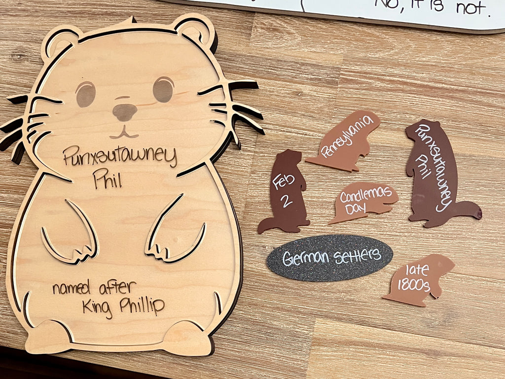 Little Dry Erasables - Groundhog Day set featuring a wooden groundhog board with labeled facts and separate wooden pieces shaped like groundhogs and signs, handcrafted homeschool education resources.