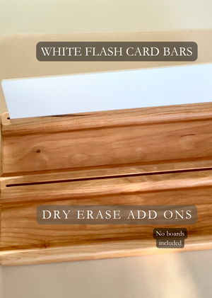 Wooden dry erase add-on bar with groove holding white flash card bars on beige surface, no boards included