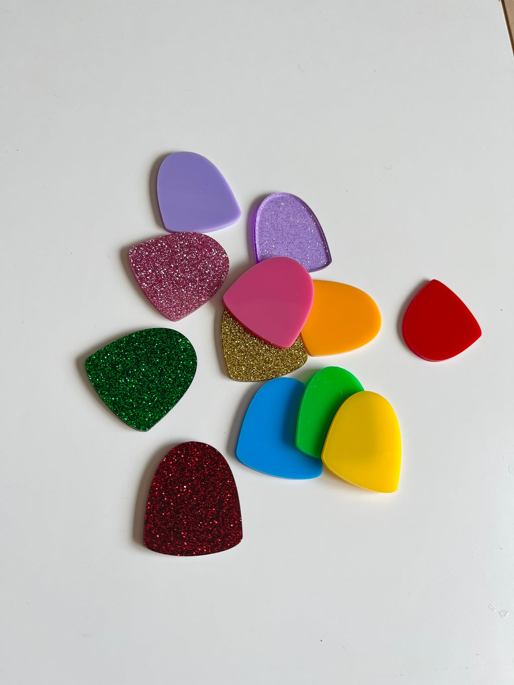 A collection of colorful plastic gumdrop-shaped pieces in purple, pink, orange, red, green, blue, and yellow, styled as Little Dry Erasables — Set of 12 Gumdrops, handcrafted homeschool educational resources.