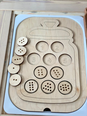 Wooden counting cookie jar insert with ten cookies featuring one to ten chocolate chip patterns on light wood table