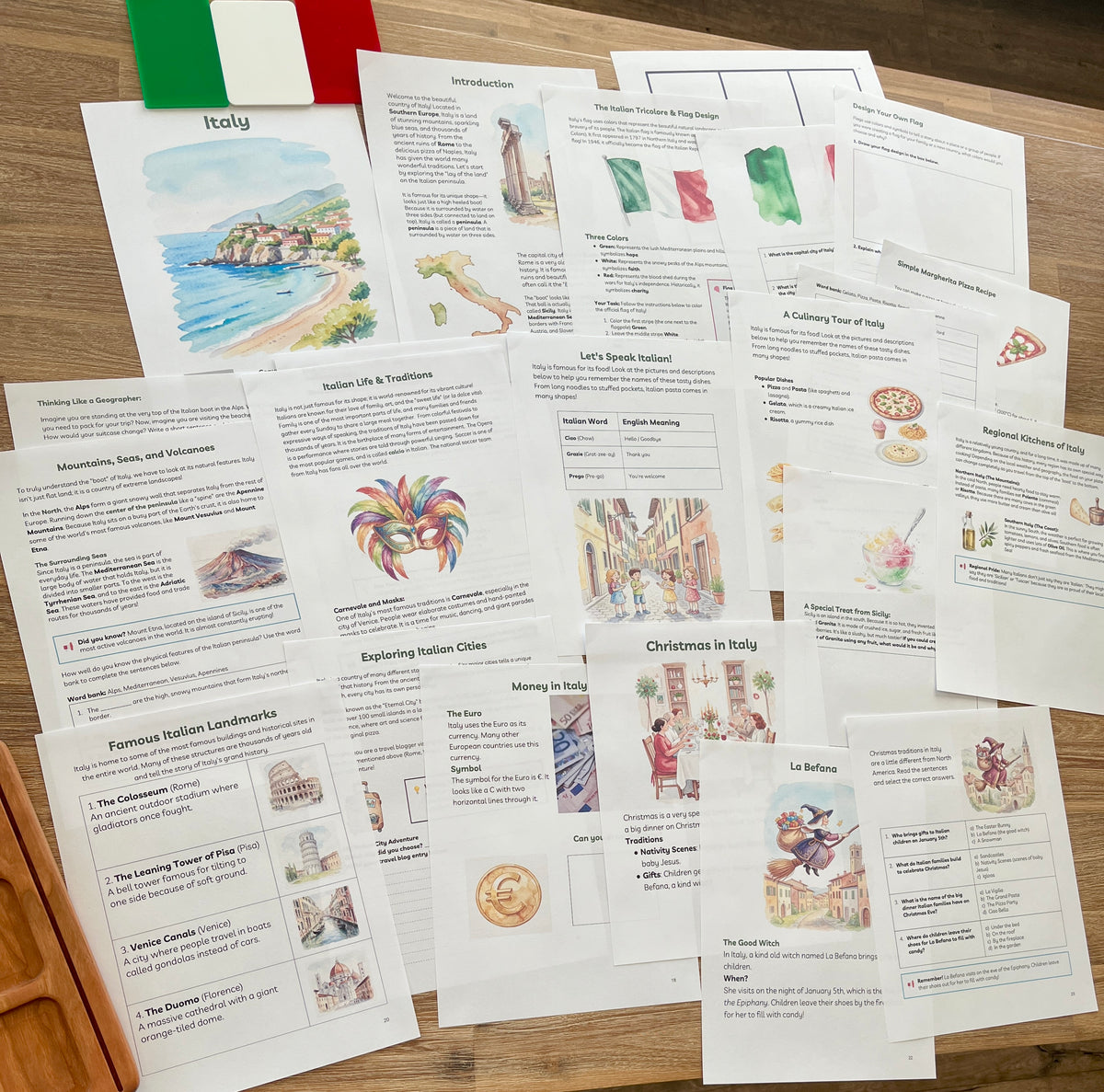 Digital Download | Italy Unit Study featuring detailed educational sheets on Italian culture, landmarks, language, and traditions displayed on a wood surface with a small Italian flag, handcrafted homeschool education resources.