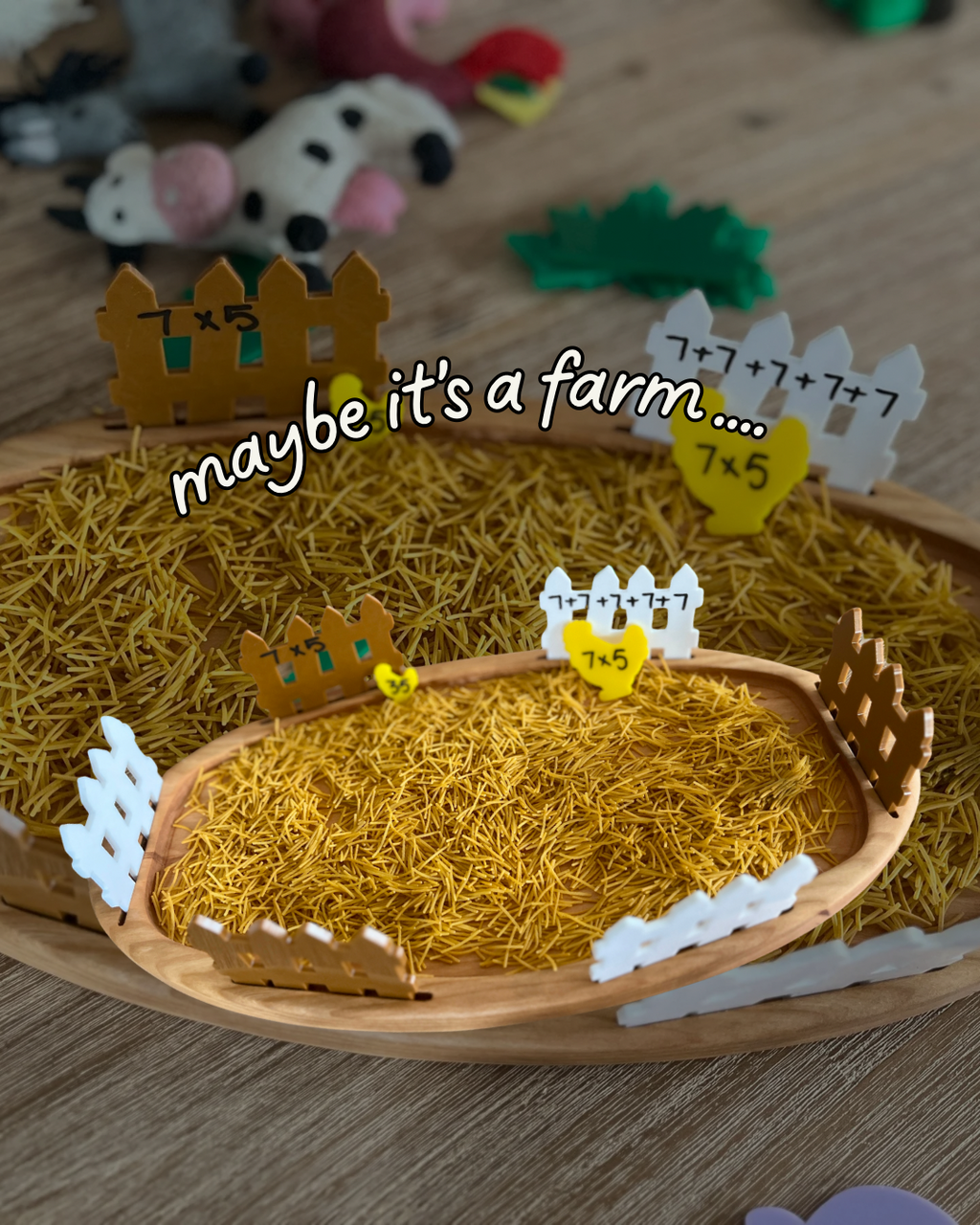 Multipurpose Oval Sensory Tray filled with yellow textured sensory filler and surrounded by wooden fence pieces with math equations, handcrafted, homeschool, education resources.
