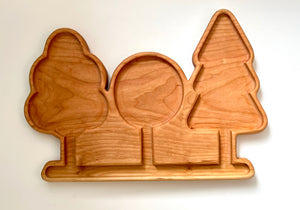 Wooden serving tray with carved sections shaped like a snowman, Christmas ornament, and pine tree on white background
