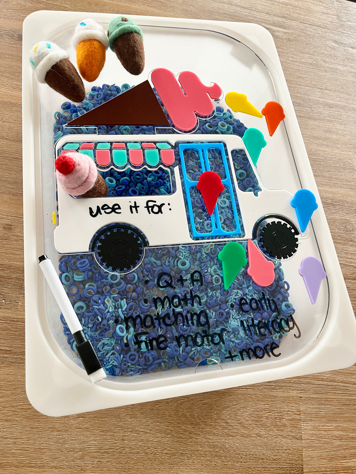 Dry Erasable Ice Cream Truck Flisat Table Bin Lid with colorful felt ice cream cones, blue sensory filler, and dry erase markers for writing and matching activities, handcrafted, homeschool, educational resources.