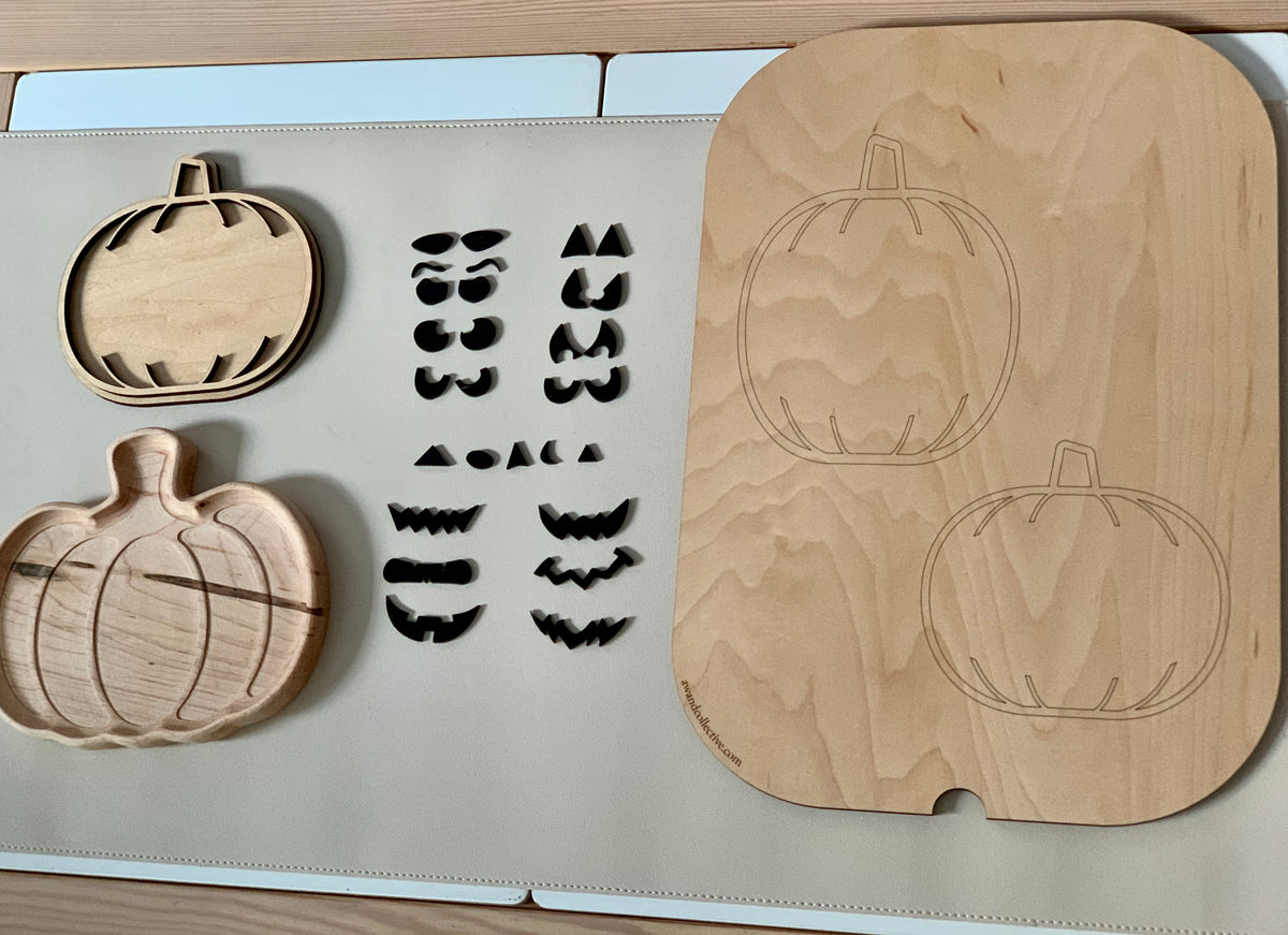 Laser cut wooden jack o lantern facial features and pumpkin shapes with slots on light surface for sensory play