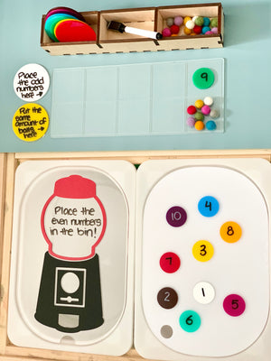 Clear learning setup with colorful number tokens, felt balls, and prompts sorting odd and even numbers on wooden trays