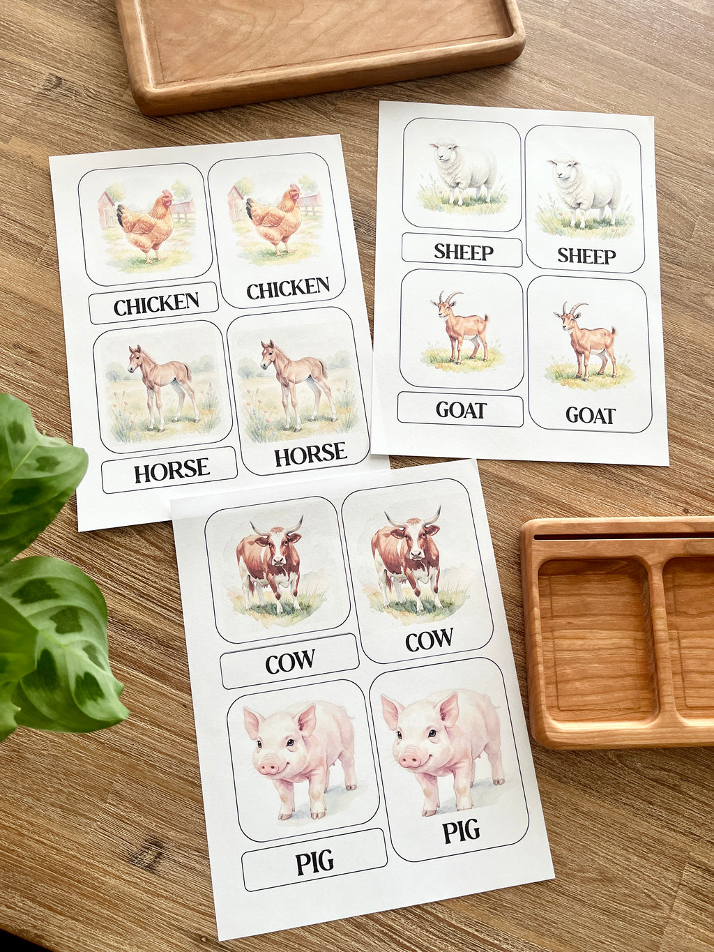 Digital Download | Farm Animal 3 Part Nomenclature Cards featuring watercolor illustrations of chicken, horse, sheep, goat, cow, and pig on a wood surface with wooden trays, handcrafted homeschool education resources.