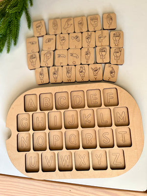 Maple wooden puzzle with removable alphabet tiles and matching American Sign Language hand signs on white surface