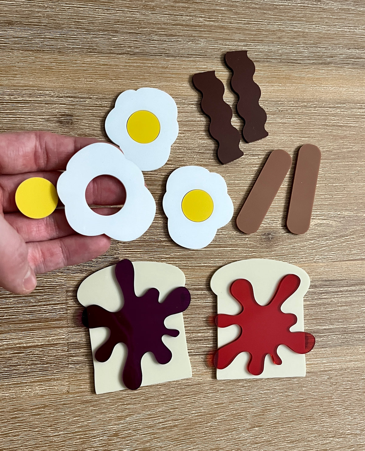 Little Dry Erasables - Breakfast Toast with Jam, Bacon, Sausage and Eggs showing handcrafted wooden play pieces of eggs, bacon strips, sausages, and toast with jam for engaging homeschool education resources.