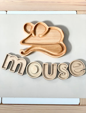 Wooden mouse-shaped sensory tray with wooden letter inserts spelling mouse on white surface with wood edges