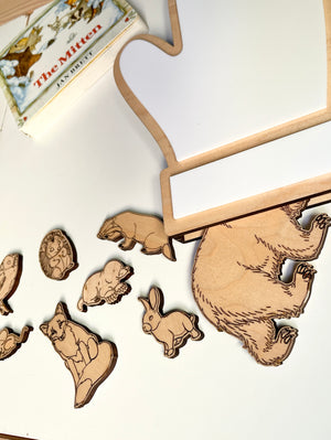 The Mitten Wooden Animals and/or Little Dry Erasables with Mitten Interactive Learning Set featuring laser-etched wooden animal pieces arranged near a mitten-shaped dry-erase board, handcrafted homeschool educational resources.