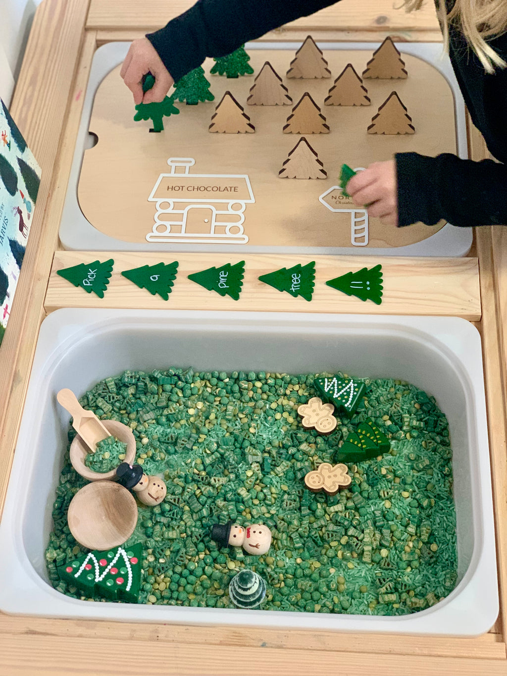 Wooden Flisat bin insert with plantable wooden Christmas trees, green sensory fill, wooden scoops, and festive figures