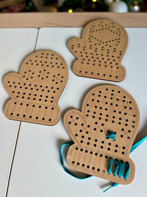 Three wooden mitten-shaped lacing boards with holes and blue lacing thread on a white surface, handcrafted homeschool educational resources for fine motor skill development.