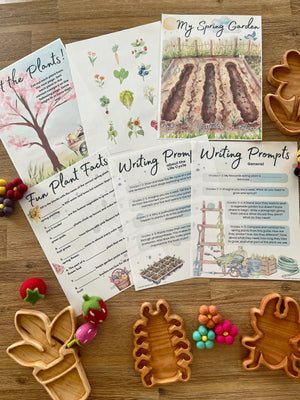 Assortment of colorful printable homeschool pages featuring spring garden illustrations, plant facts, and writing prompts arranged with handcrafted wood trays and felt sensory toys for Digital Download | Spring Gardening Complete Unit Study with unique handcrafted homeschool education resources.