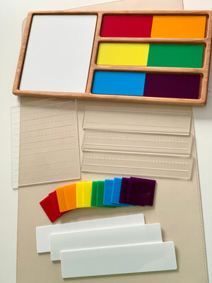 Wooden tray with stacked colorful transparent squares and white rectangular panels on a beige surface