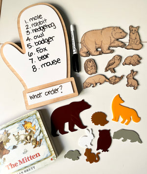 The Mitten Wooden Animals and/or Little Dry Erasables with Mitten Interactive Learning Set featuring natural wood and colorful animal figures, a mitten-shaped dry-erase board with handwritten animal names and questions, unique handcrafted homeschool education resources.