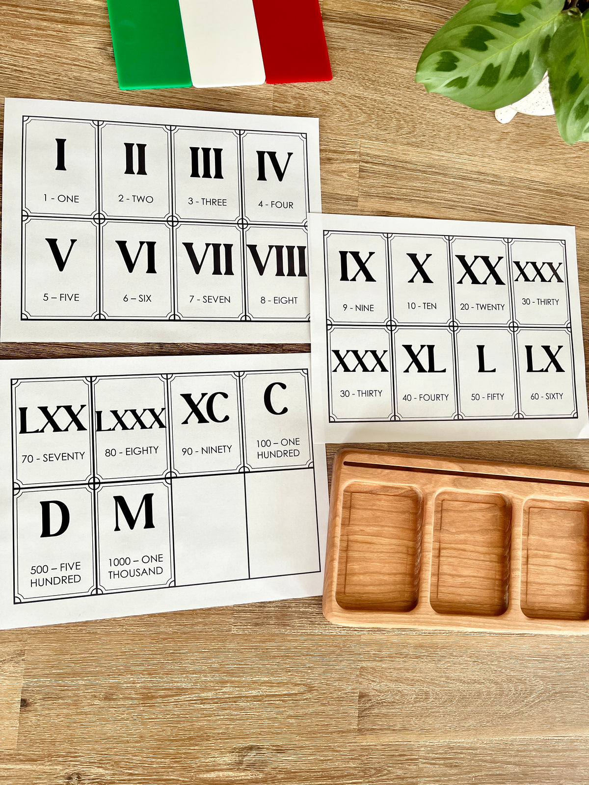Digital Download | Roman Numeral Flash Cards displaying printable cards with Roman numerals and corresponding numbers arranged on a wooden surface next to a wooden tray, handcrafted homeschool education resources.