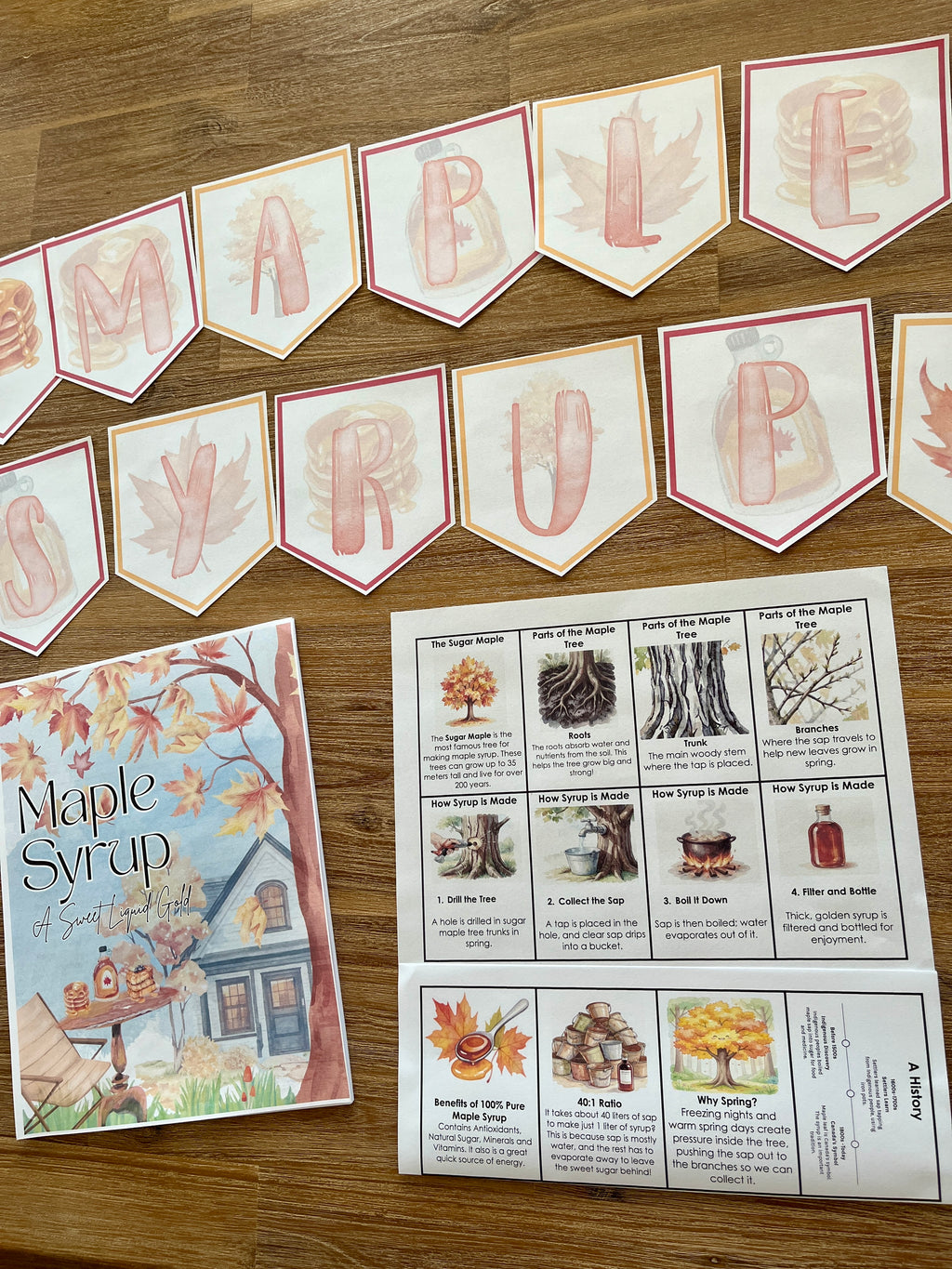 Digital Download | Maple Syrup Unit Study displaying educational banner with themed letters, illustrated booklet, and informational worksheet laid out on a wood surface, handcrafted homeschool education resources.