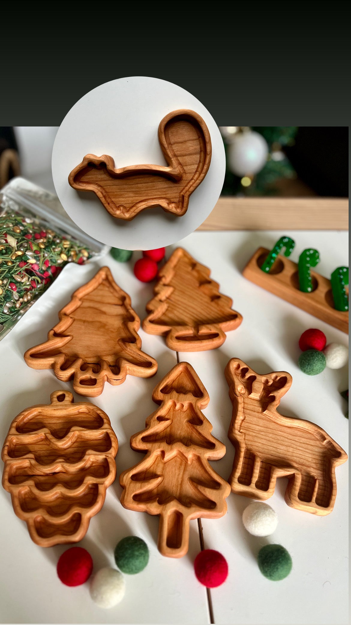Wooden decorative trays shaped like a pinecone, various evergreen trees, a reindeer, and a squirrel on a white surface.