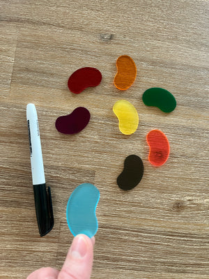 Little Dry Erasables — Jellybeans with Jar showing translucent colorful bean-shaped pieces in various hues next to a black marker, handcrafted homeschool education resources.
